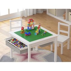 a child's table and chair with toys on it