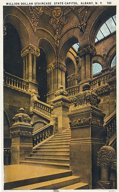 an old postcard shows the staircases and arches in a building with arched windows