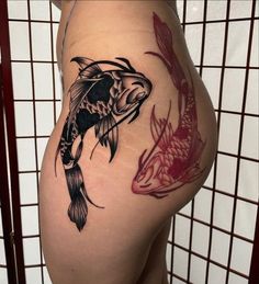 a woman's thigh with a fish tattoo on it