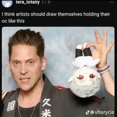 a man is holding up his hand with an animal mask on it