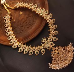 About the Jewellery Introducing our exquisite South Indian Traditional Handmade Kundan Mango Necklace! This captivating piece showcases the timeless beauty of Jadau Kundan craftsmanship. Meticulously created by skilled artisans, each intricate detail reflects the rich heritage of South India. Be prepared to turn heads with the elegance and splendor of this lightweight necklace, perfect to complement both traditional and contemporary ensembles. Step into a world of regal charm and celebrate your unique style with our stunning Kundan mango necklace. Details & Specifications: Materials used: Silver,Brass Polish- Primary Colour -Gold Secondary Colour -Gold Finish -Gold Stone's-Jadau Kundan  Beads-Pearls  Length -28 Inches Weight -  Earrings-No Earrings Length - Earrings Weight - Type - Push ty Luxury Gold-plated Kundan Necklace For Diwali, Traditional Luxury Yellow Gold Kundan Necklace, Temple Jewelry Necklace With Cutdana For Eid, Temple Jewelry Temple Necklace With Cutdana For Eid, Eid Temple Jewelry Necklace With Cutdana, Mango Mala Jewellery Gold, Mango Mala Jewellery, Vanki Ring, Mango Mala