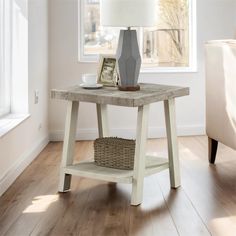 a table with a basket underneath it and a lamp next to it on a hard wood floor