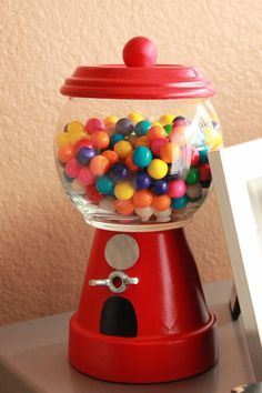 a red gummy machine sitting on top of a table