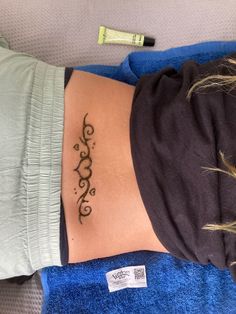 a woman's stomach with a tattoo on her lower back and the word hope written in cursive writing