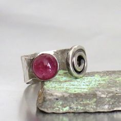 Silver Tourmaline Ring, Open Silver Ring, Adjustable Ring, Sterling Silver, Hand Made Ring, Gemstone Ring, Bezel Set Stone, Pink Stone Ring I handmade this ring by hammering a piece of solid sterling silver to an open ring. It has a Silver spiral on one end and a round bezel set Pink Tourmaline gemstone on the other. Measurements: -------------------- ✪  Ring size - as it is made to order, please let me know your wanted size. ✪  Gemstone Size - diameter of 8mm and adjustable. ------------------- Modern Silver Ring, Pink Stone Rings, Unique Silver Rings, Tourmaline Jewelry, Handmade Jewelry Designs, Tourmaline Ring, Handmade Rings, Silver Rings Handmade