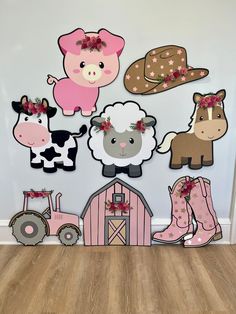 a wall with farm animals and farm themed decorations on it's sides, including a cow, pig, horse, barn, and tractor