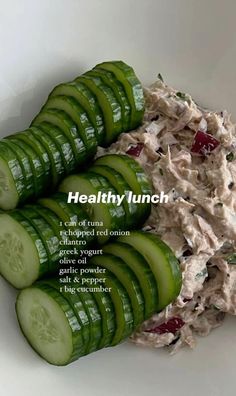 cucumber slices and tuna salad in a white bowl with the caption healthy lunch