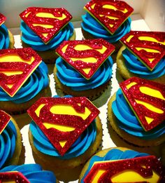 cupcakes with blue frosting and red icing decorated like superman's logos