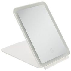 an electronic device sitting on top of a white surface with its reflection in the screen