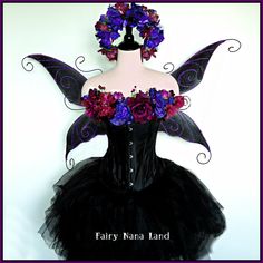 a black corset with purple and red flowers on the top, attached to a mannequin