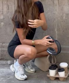 a woman sitting on the ground with her legs crossed