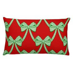 a red pillow with green bows on it