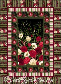 a red and white quilt with flowers on it's border, in the center