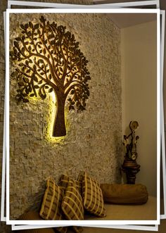 a decorative tree is mounted on the wall next to pillows