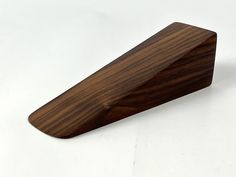 a wooden object sitting on top of a white table