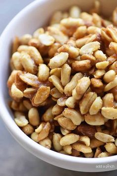 a white bowl filled with nuts on top of a table