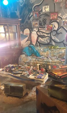 a living room filled with furniture and graffiti on the wall