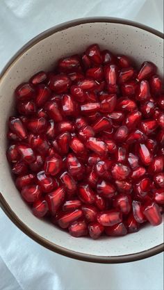 pomegranate in a bowl on a white tablecloth