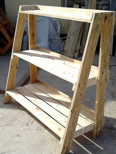 a wooden shelf sitting on top of a cement ground