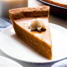 a slice of pumpkin pie with whipped cream on top