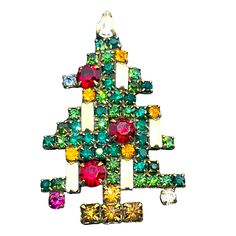 a christmas tree brooch with multi colored stones