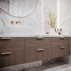 a bathroom with marble counter tops and wooden drawers