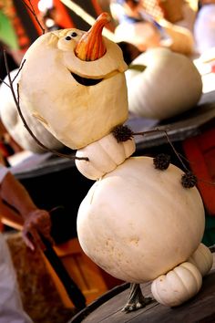 a close up of a person made out of pumpkins and other items in the background