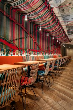 a row of chairs sitting next to each other on top of a wooden floor