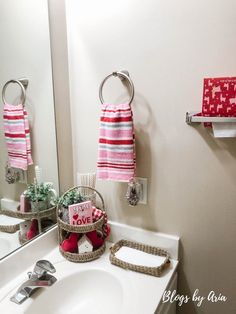 a bathroom sink with two towels hanging on the wall