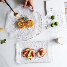 there are two plates with food on them, one is cut in half and the other has fruit