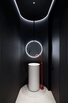 a black and white bathroom with a round mirror