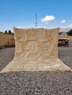 a large blanket sitting on top of gravel