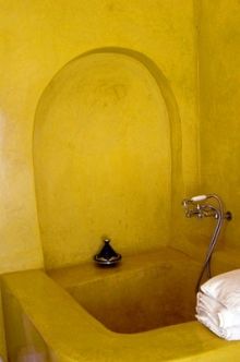 a yellow bathroom with a sink, toilet and bathtub