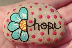 a painted rock with the word hope written on it