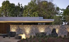 an outdoor area with stone walls and lights