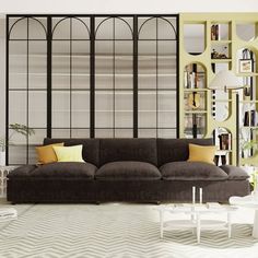 a living room filled with furniture and lots of books on the shelves in front of it