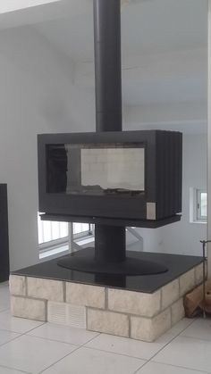 a black stove sitting in the middle of a living room