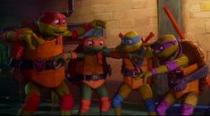 teenage mutant ninjas are standing together in front of a brick wall