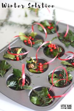 cupcake tins filled with holly and red ribbon for winter solstice decorations