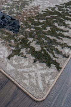 an area rug on the floor with wood floors