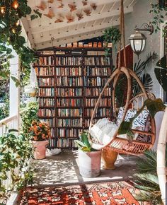 a room filled with lots of books and plants