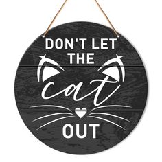 a sign that says don't let the cat out on it with an image of a