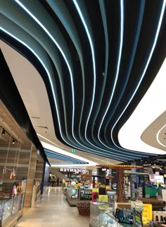 the interior of a shopping mall with blue lights