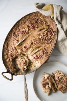 a pie sitting on top of a white plate next to two pieces of cake covered in toppings