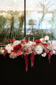 a table with flowers and candles on it