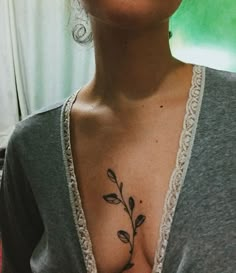 a woman with a flower tattoo on her chest