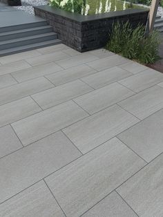 an outdoor patio with steps and plants