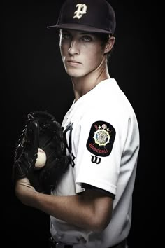 a baseball player is posing for a portrait with his mitt and ball in hand