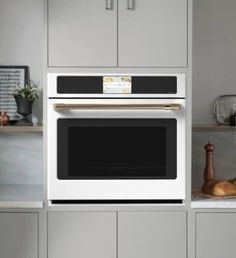 a kitchen with gray cabinets and stainless steel appliances, including a built - in microwave