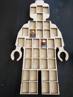 the lego man is made out of cardboard and has multiple compartments for small items to put in it